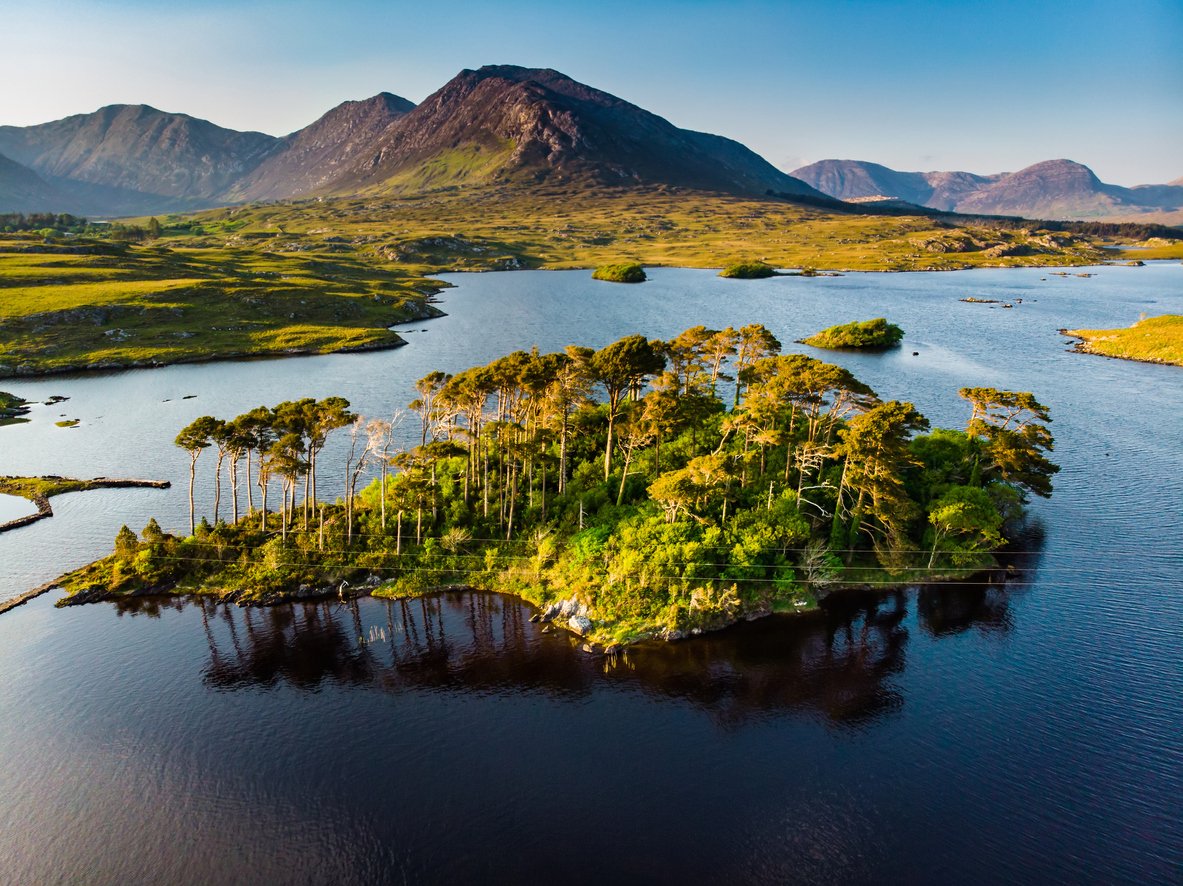 Twelve Pines Island, standing on a gorgeous background formed by the sharp peaks of a mountain range called Twelve Pins or Twelve Bens, Connemara, County Galway, Ireland